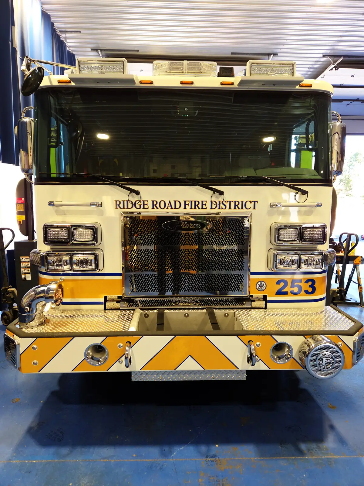 Pumper front view showing grille, bumper-mounted intake, and warning lights