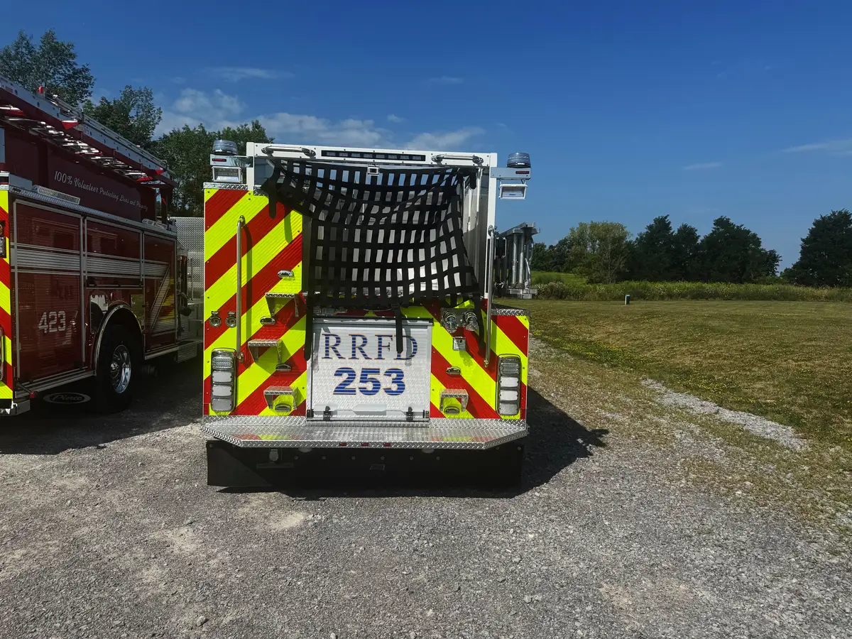Rear exterior view showing chevron striping, hosebed netting, and rear lights