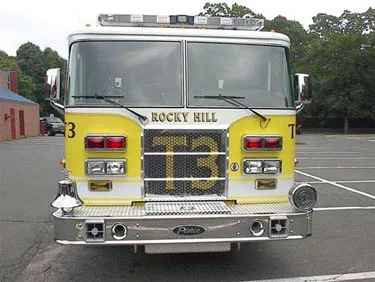 Front exterior view showing grille, bumper, and warning lights