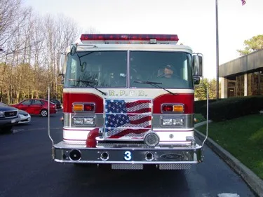 Front exterior view showing grille, bumper, and warning lights