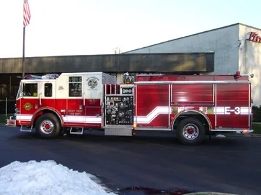 Driver-side profile view showing pump panel and wheel area
