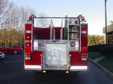 Rear view showing rear warning lights, hosebed opening, and rear panel