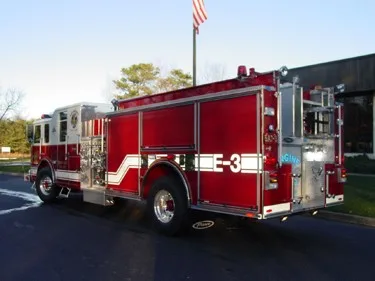 Rear-right exterior view showing side body compartments and rear wheel