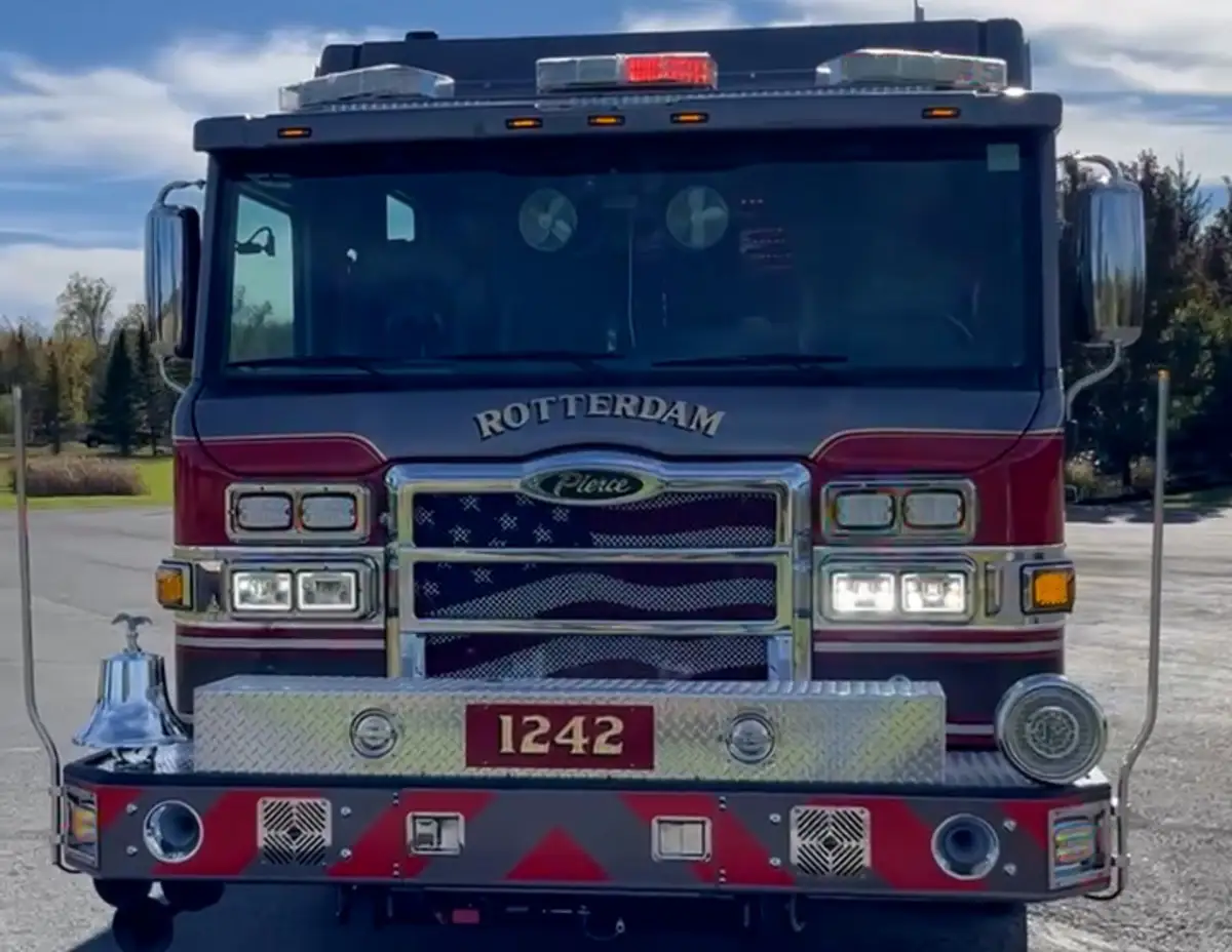 Head-on front view showing grille, bumper, and warning lights