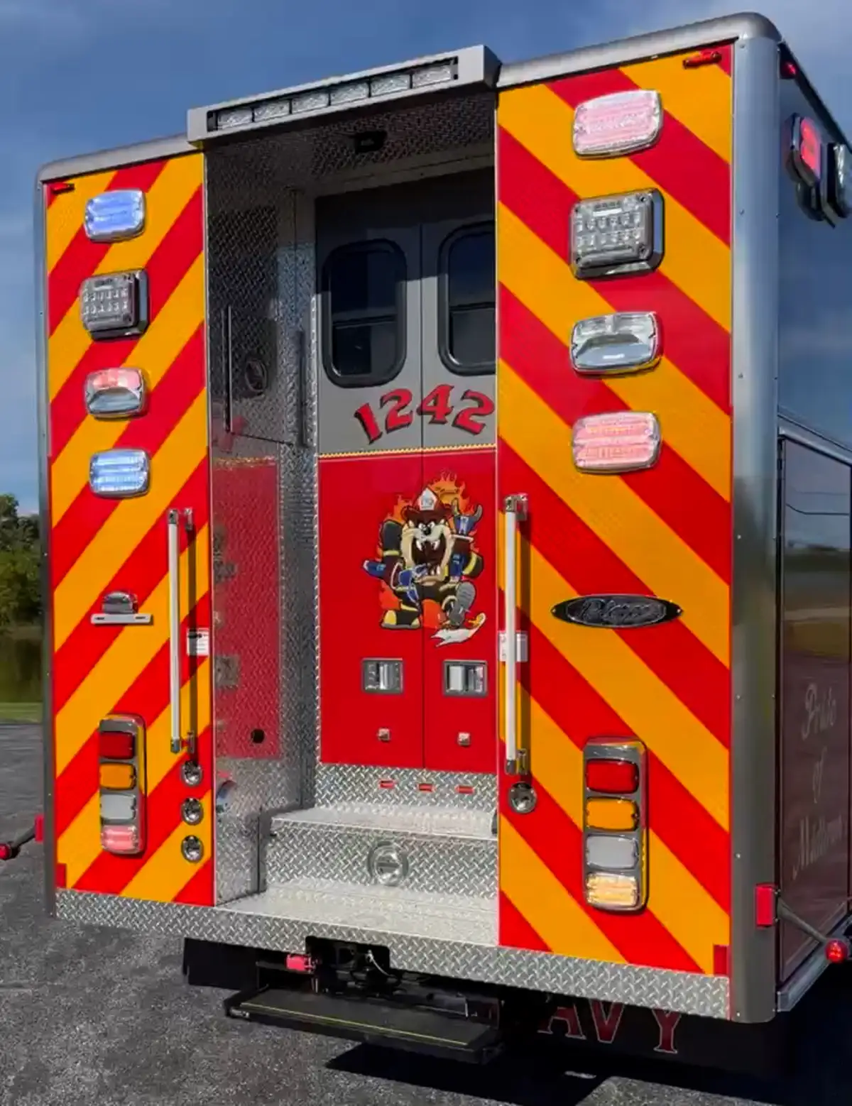 Rear view showing red-and-yellow chevrons and centered rear doors