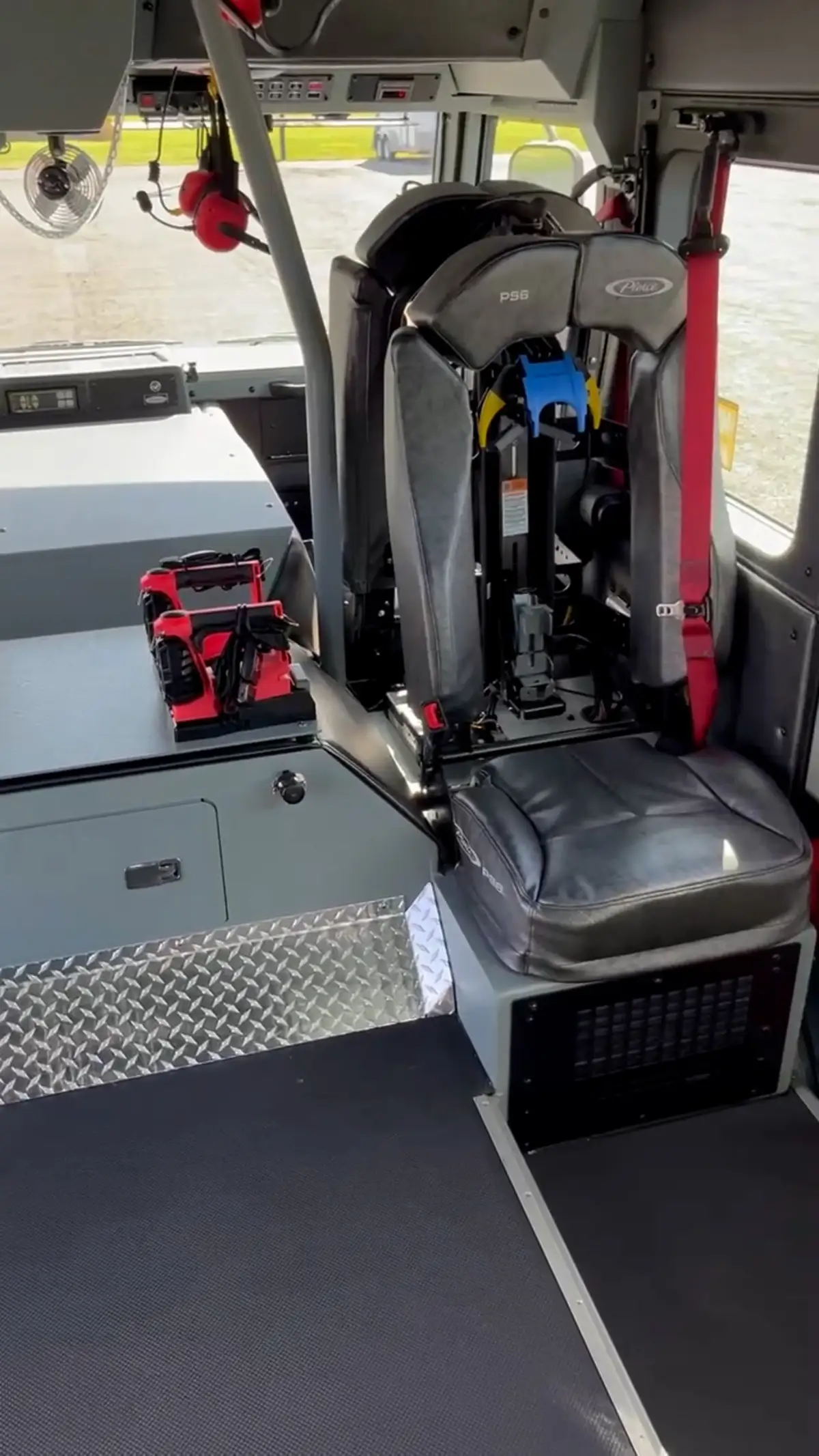 Cab interior rear-seat close-up showing seat backs and restraints