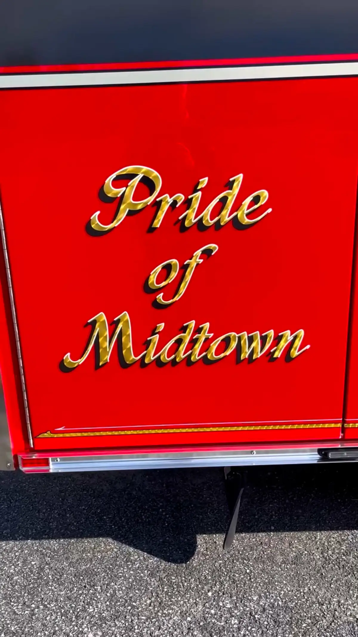 Body panel close-up showing decorative lettering on red paint