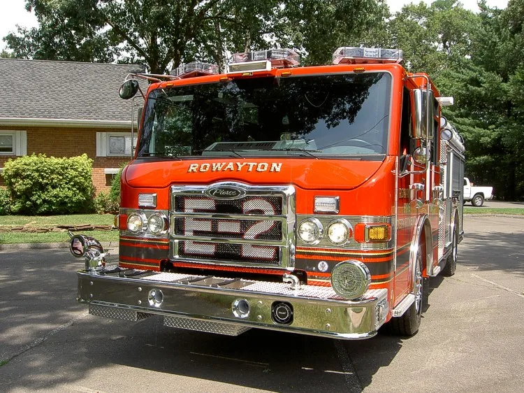 Front-left close view showing grille, bumper, and warning lights