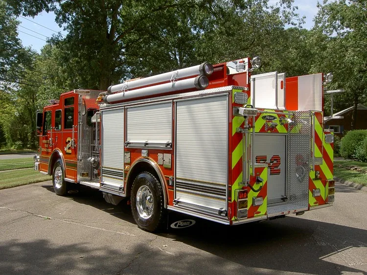 Rear-right exterior view showing side compartments and rear wheel area