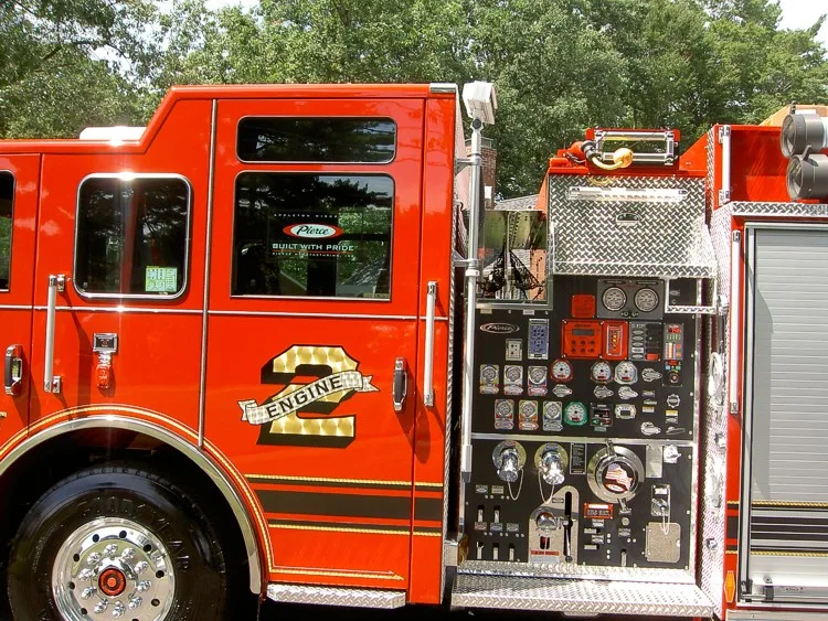 Pump panel close-up showing gauges, valves, and hose connections