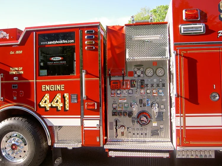 Driver-side pump panel close-up showing gauges, valves, and intake connections