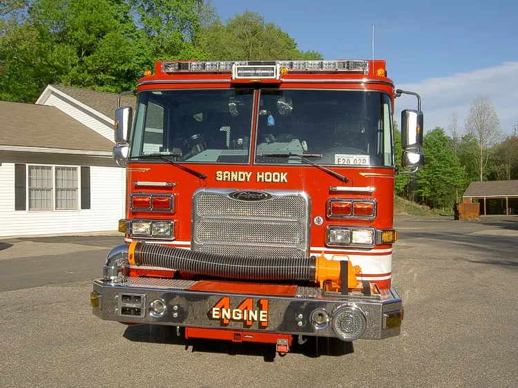 Front exterior view showing grille, bumper, and warning lights