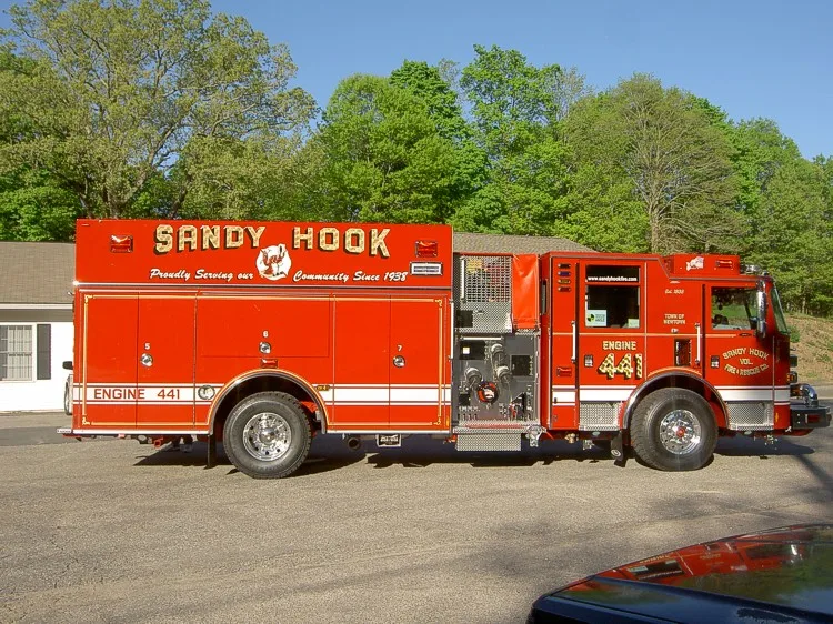 Driver-side profile view showing pump panel and side compartments
