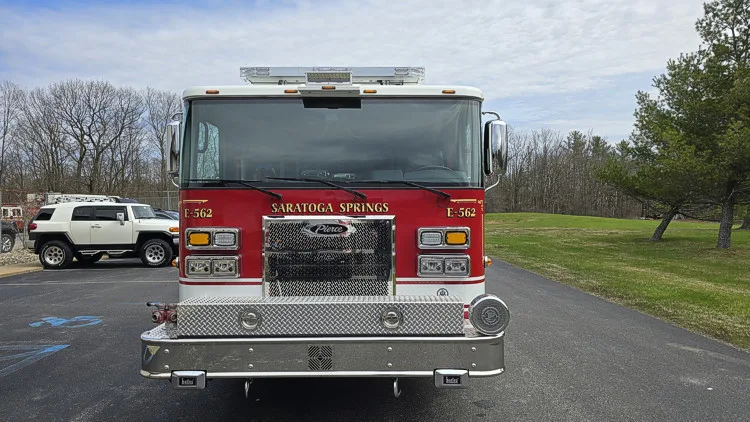 Pumper front view showing grille, warning lights, and bumper-mounted siren