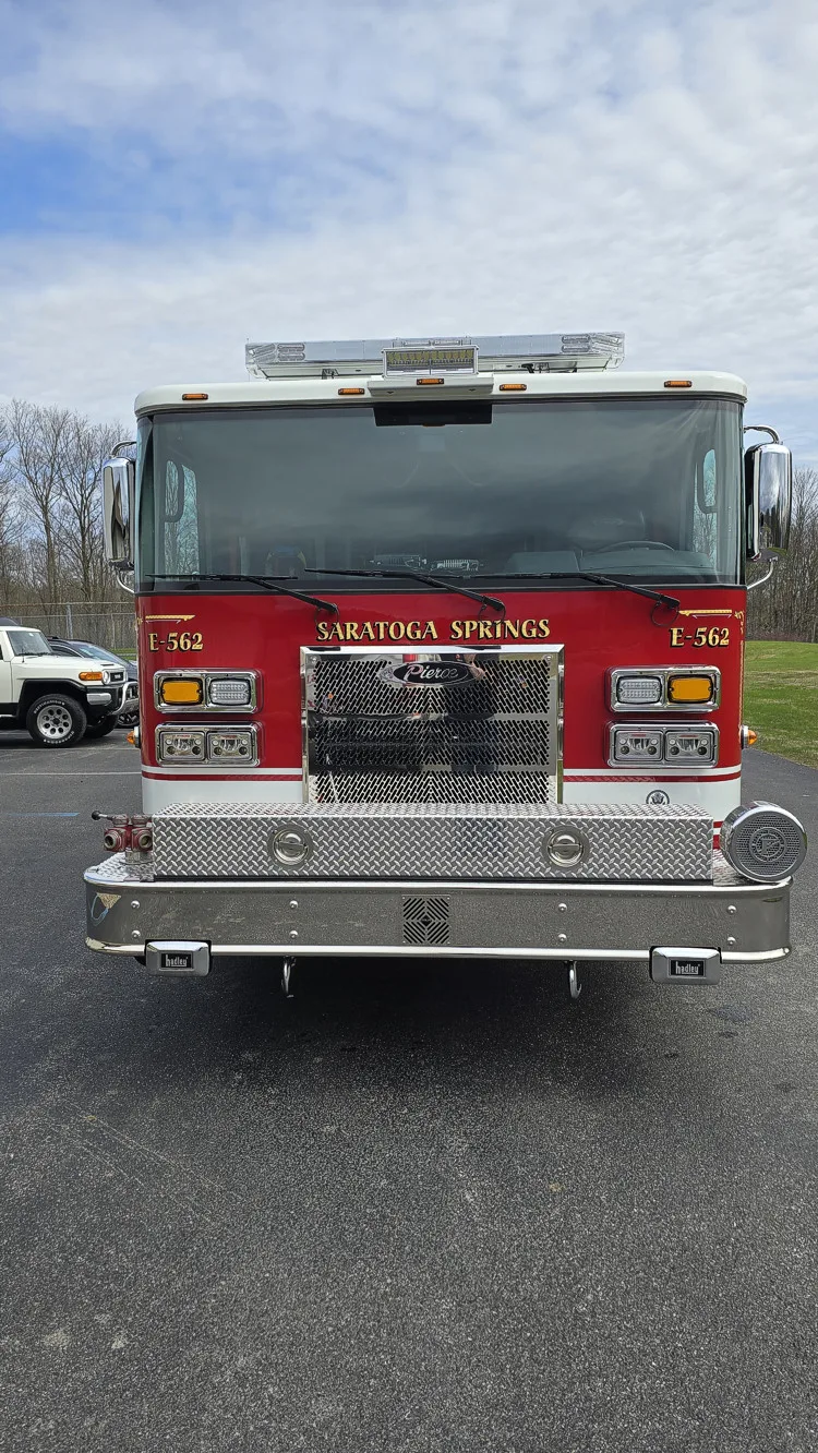 Pumper front view showing grille, bumper intake, and warning lights