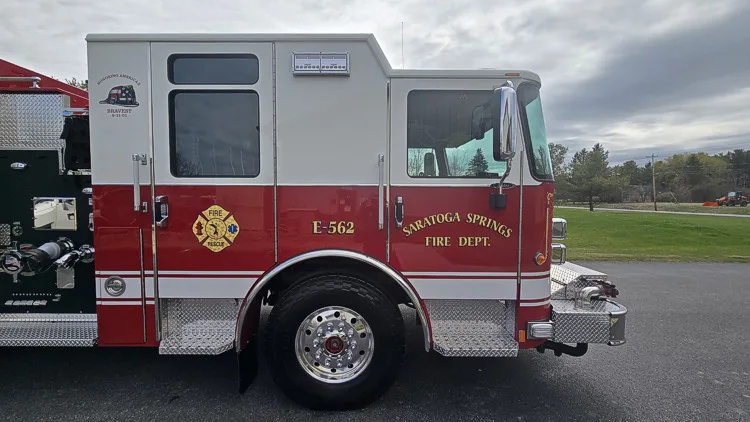 Cab side close-up showing crew-cab doors, front wheel, and bumper intake