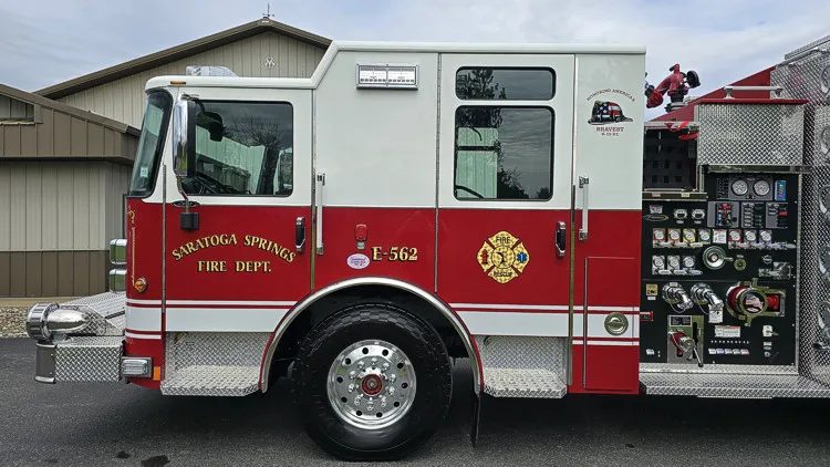 Cab and pump-panel close-up showing gauges, valves, and side controls