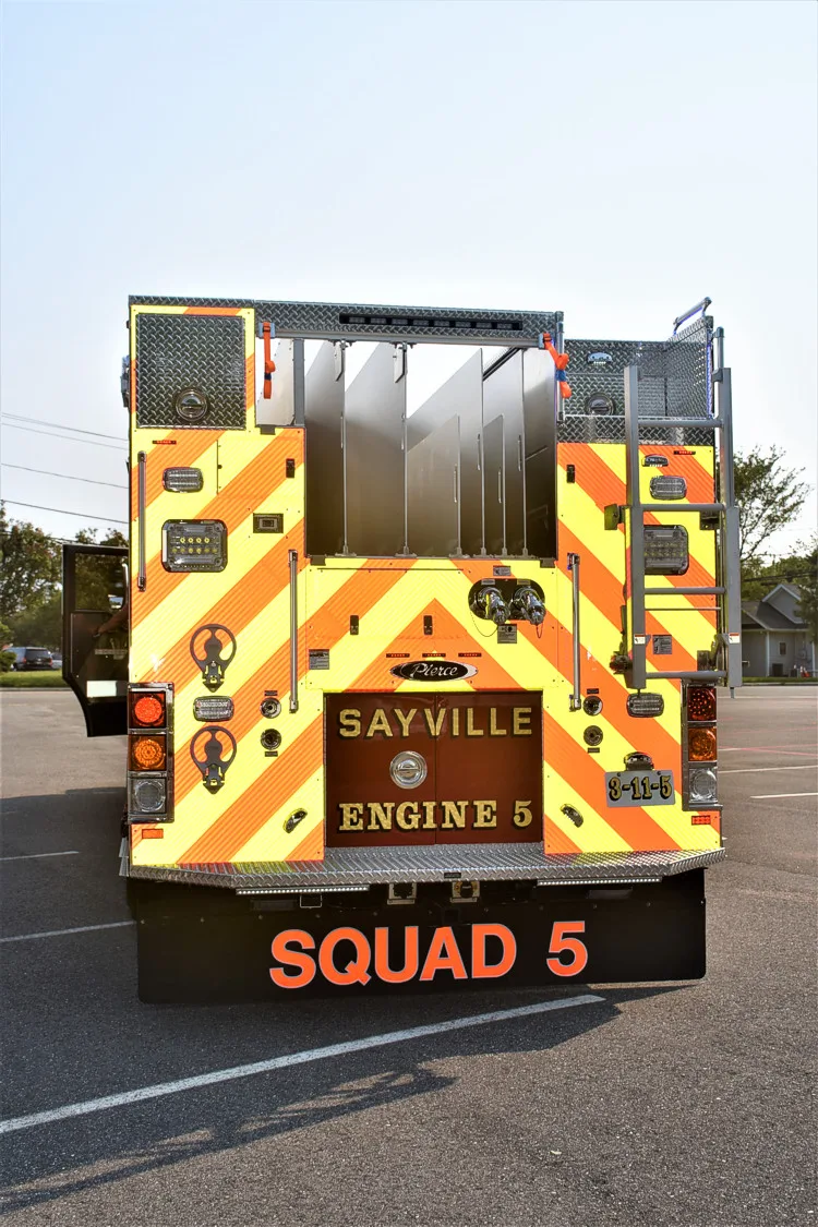 Rear view showing red-and-yellow chevrons, rear lights, and rear body panel
