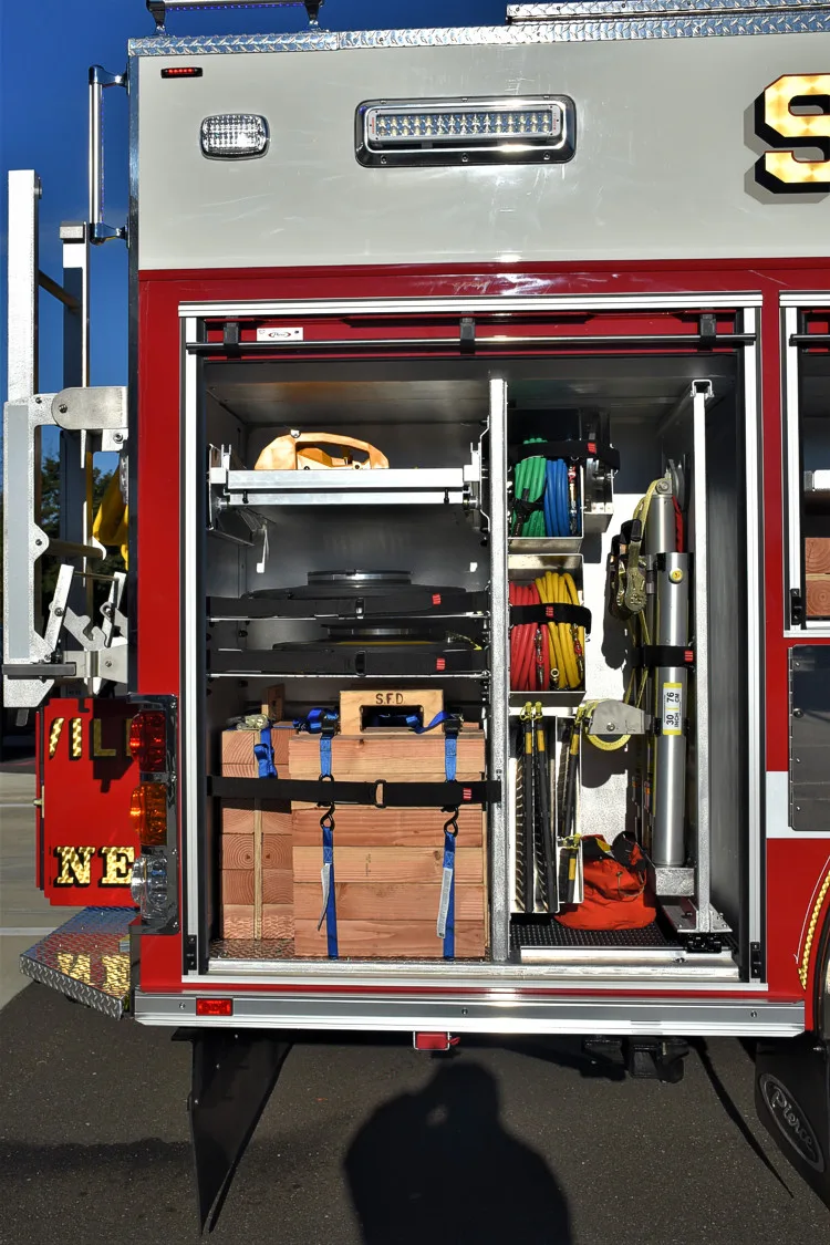 Open side compartment showing storage crates, bags, and shelf organization