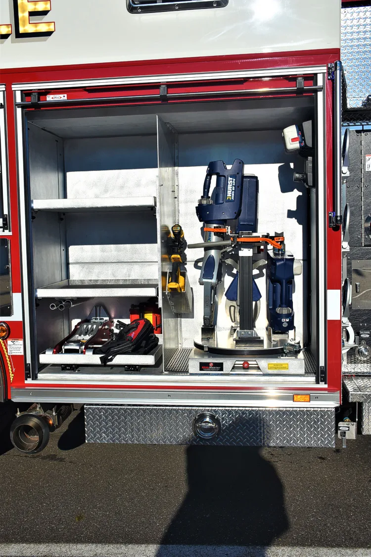 Open side compartment showing mounted nozzles, fittings, and equipment shelves