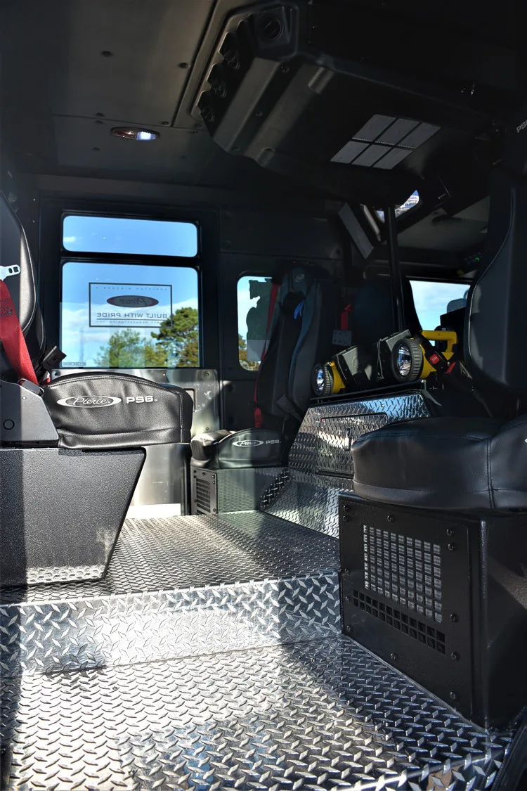 Crew cab interior view showing aisle, seating, and rear compartment area