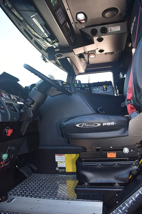 Front cab interior view showing center console, dashboard controls, and windshield