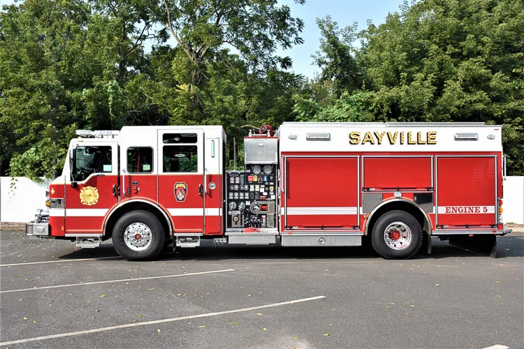 Driver-side full profile view showing pumper body and rear wheel area
