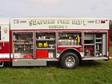 Driver-side view with compartment doors open showing tools and equipment storage shelves