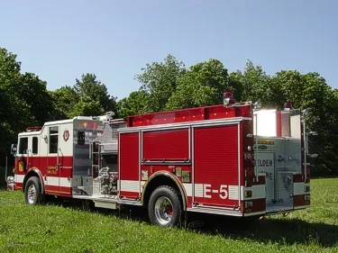 Rear-right exterior view with side compartments, rear body panel, and wheel/tire area.