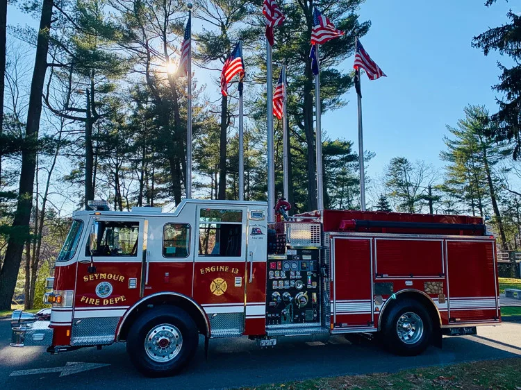 Driver-side profile view showing pumper body and rear wheel area
