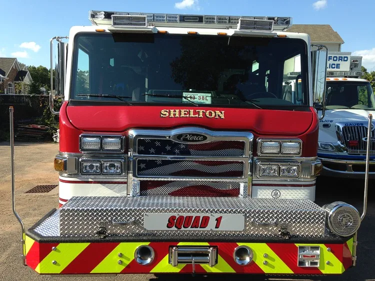 Front exterior view showing grille, bumper, and warning lights