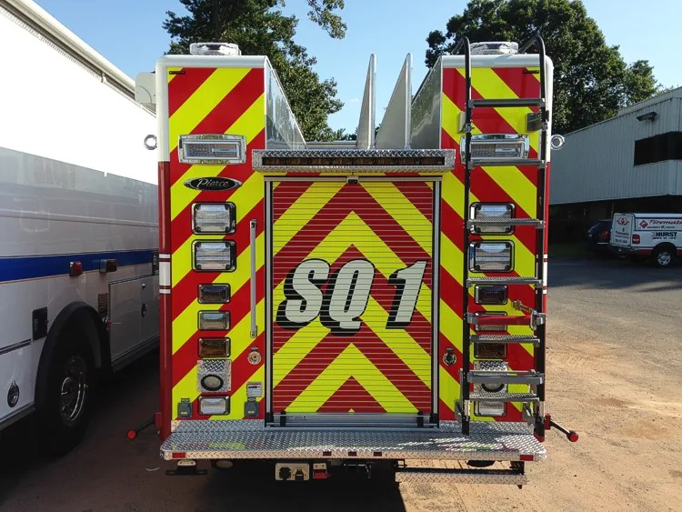 Rear view showing chevron striping, rear door panel, and upper ladders