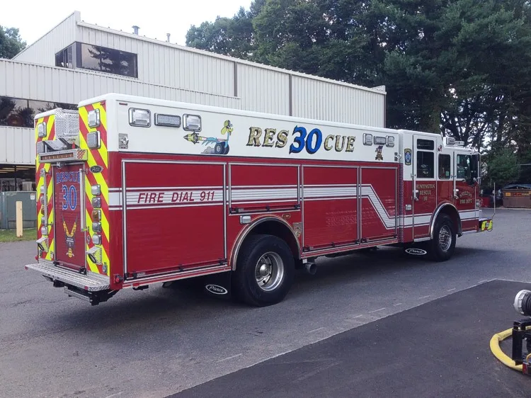 Rear-right exterior view showing long body, rear axles, and side compartments