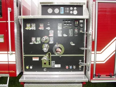 Pump panel close-up showing gauges, valves, and discharge controls