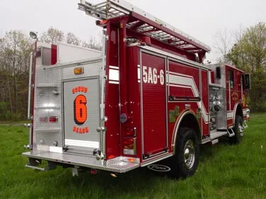 Rear-right exterior view showing hosebed, roof ladders, and rear body panel