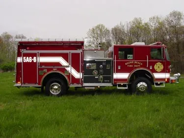 Driver-side profile view showing pump panel area and side body compartments