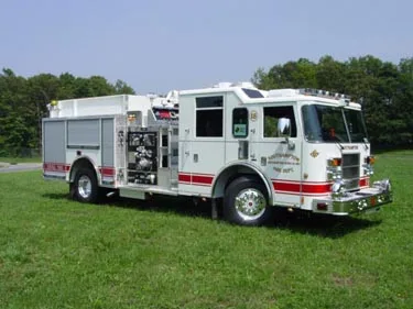 Pumper-tanker front-right view showing side pump panel and water tank body