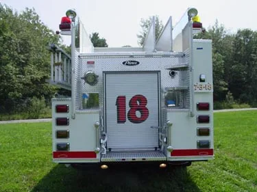 Rear view showing rear door, upper ladder rack, and rear warning lights