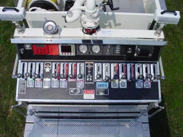 Rear control panel close-up showing gauges, valves, and labeled pump controls