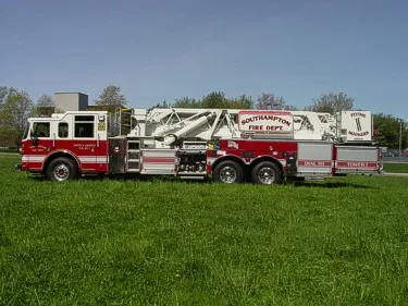 Full right-side profile showing the mid-mount ladder assembly, body compartments, and wheel layout.