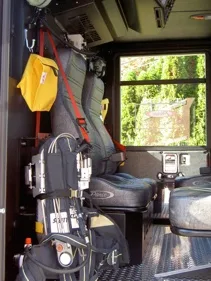 Rear crew seat interior view showing SCBA mounts and seat harnesses