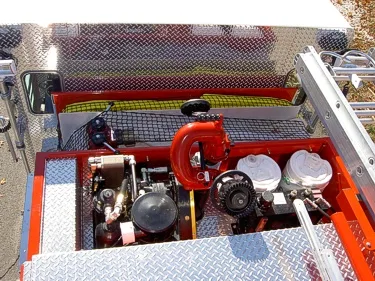 Hosebed equipment close-up showing deck gun plumbing and intake fittings