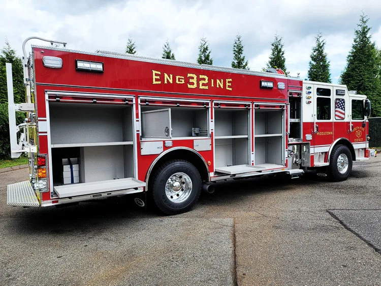 Driver-side profile with open compartments showing tools and shelf storage