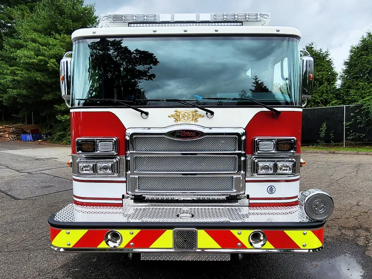Head-on front view showing grille, bumper, and warning lights