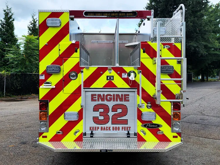 Rear view showing red-and-yellow chevrons and large unit number panel