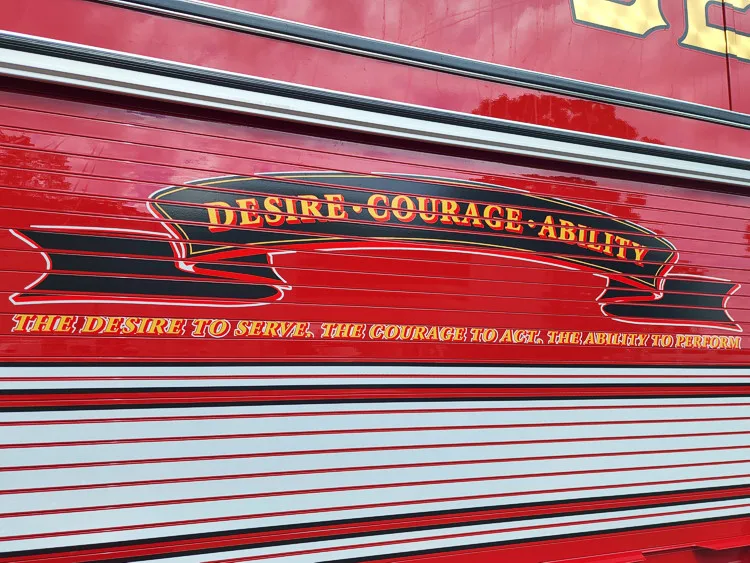 Body side close-up showing decorative script on red roll-up door