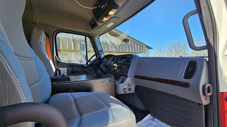 Cab interior side view showing front passenger seat and dashboard
