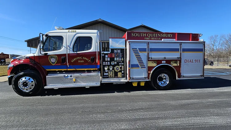 Driver-side profile with open compartments showing pump panel and tool bays