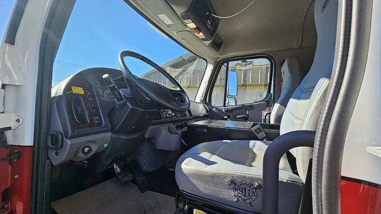 Driver cockpit view showing steering wheel, dashboard, and center controls