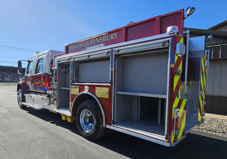 Rear-left profile showing open side compartments and rear body section